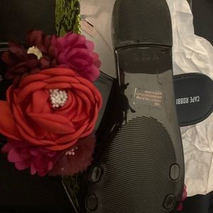 Black Jelly sandals with flowers on it never worn just tried on. Sized 10